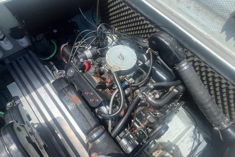 Slide: The Image of Engine compartment of a 1988 Seafox 29 Flybridge boat, showcasing detailed mechanical components. - 24