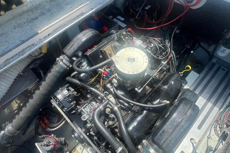 Slide: The Image of Engine compartment of a 1988 Seafox 29 Flybridge boat, showcasing detailed mechanical components. - 25