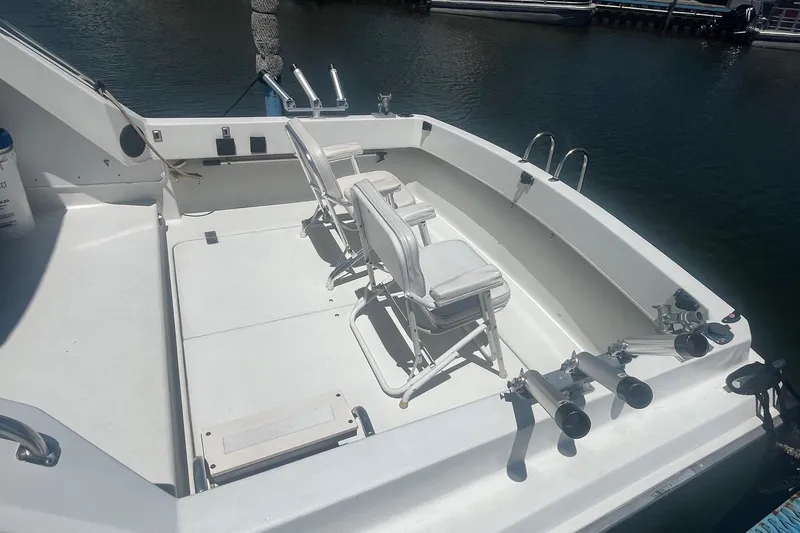 Slide: The Image of 1988 Seafox 29 Flybridge boat deck with chairs and fishing rod holders. - 3