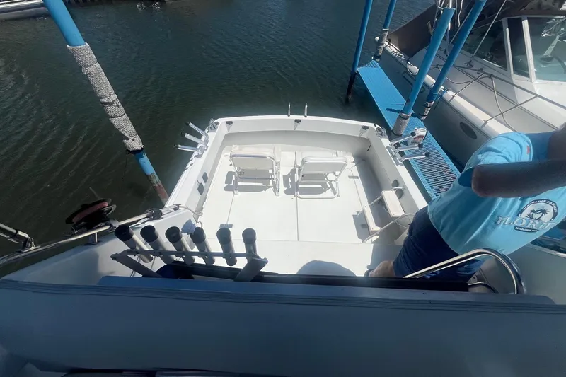 Slide: The Image of 1988 Seafox 29 Flybridge boat deck with fishing rod holders and chairs. - 6