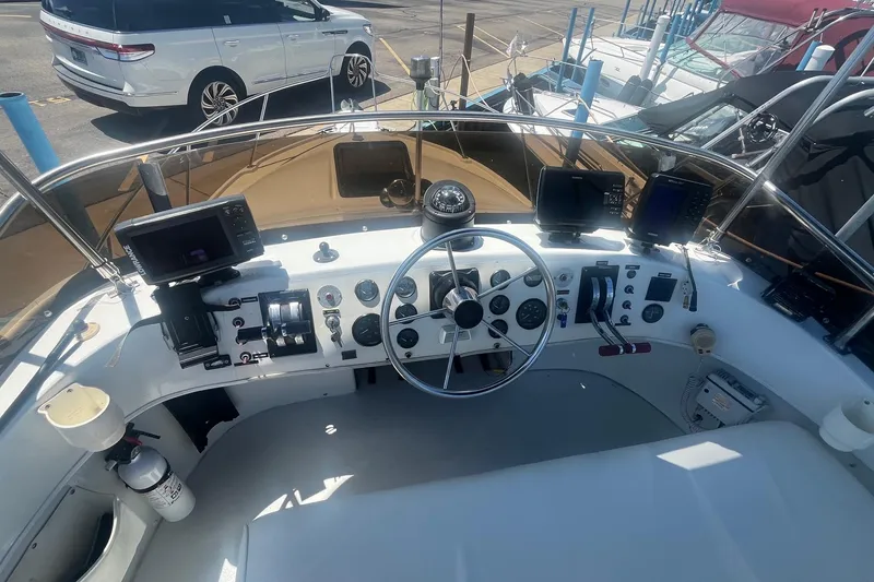 Slide: The Image of 1988 Seafox 29 Flybridge helm with steering wheel, gauges, and navigation equipment. - 8