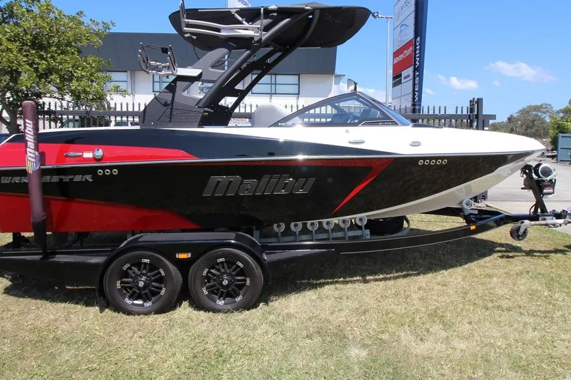 The Image of 2018 Malibu Wakesetter 20 VTX boat on trailer, black and red design. - 1