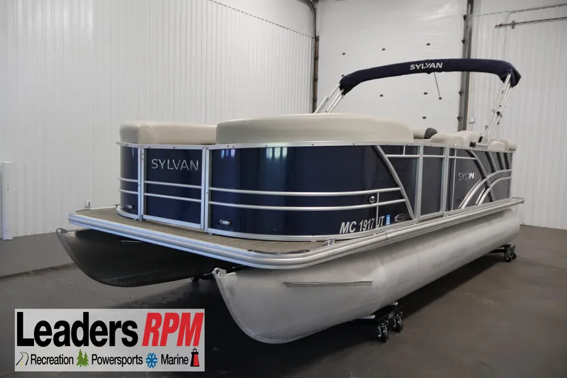 Slide: The Image of 2022 Sylvan 8520 Mirage pontoon boat in showroom, featuring sleek design and modern amenities. - 1