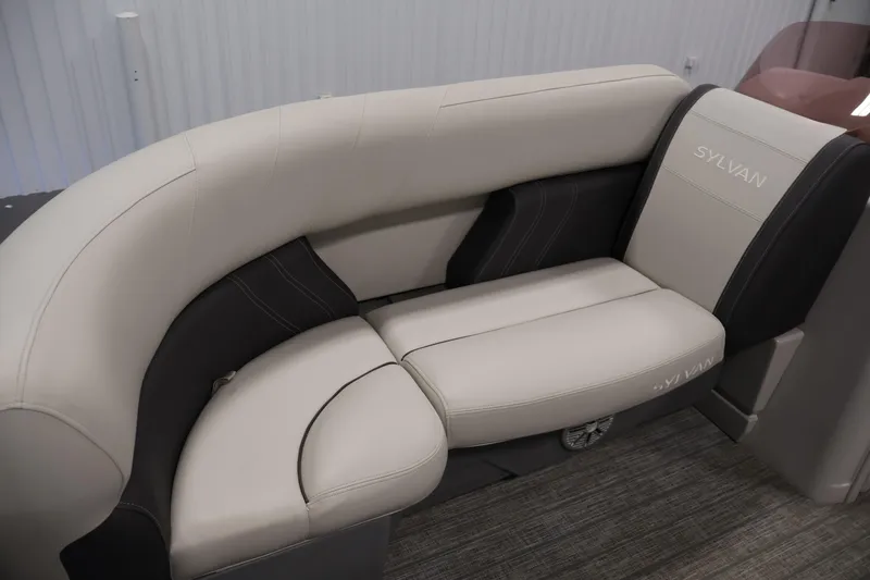 Slide: The Image of 2022 Sylvan 8520 Mirage boat interior with beige and black seating. - 14