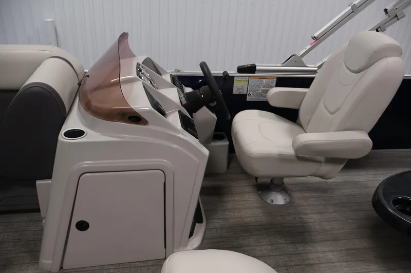 Slide: The Image of 2022 Sylvan 8520 Mirage boat interior with steering console and captain's chair. - 16