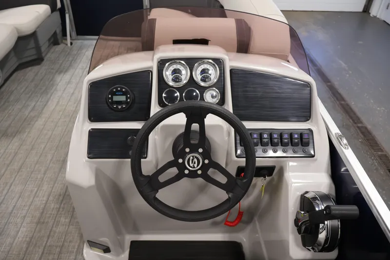 Slide: The Image of 2022 Sylvan 8520 Mirage boat dashboard with steering wheel and control panel. - 17