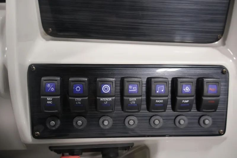 Slide: The Image of Control panel of 2022 Sylvan 8520 Mirage boat with labeled switches. - 22