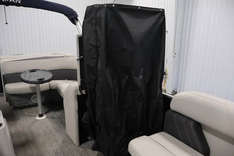 Slide: The Image of 2022 Sylvan 8520 Mirage interior with seating, table, and privacy curtain. - 27