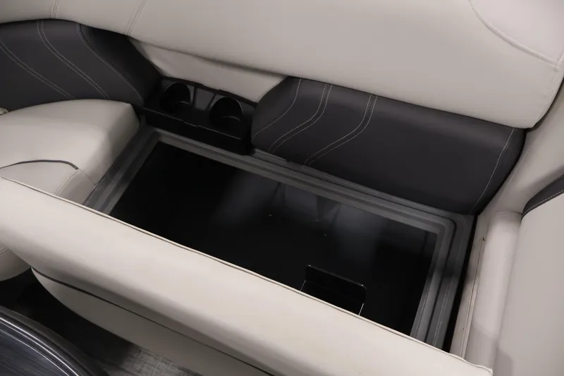Slide: The Image of 2022 Sylvan 8520 Mirage boat interior storage compartment with cup holders and cushioned seating. - 28