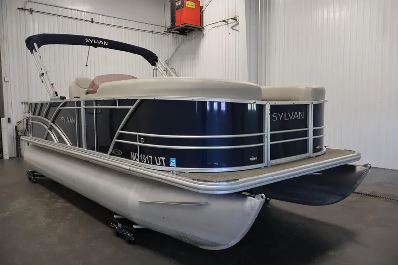 Slide: The Image of 2022 Sylvan 8520 Mirage pontoon boat in indoor storage facility. - 3