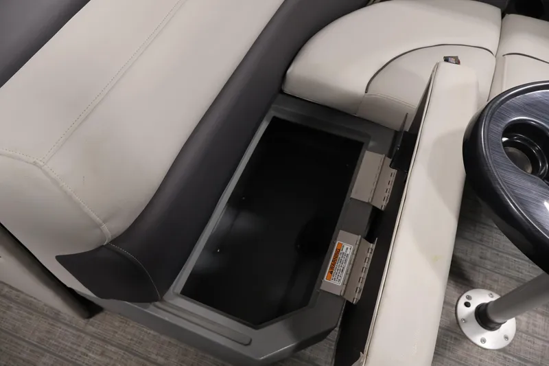 Slide: The Image of 2022 Sylvan 8520 Mirage boat interior with open storage compartment and cup holder. - 30