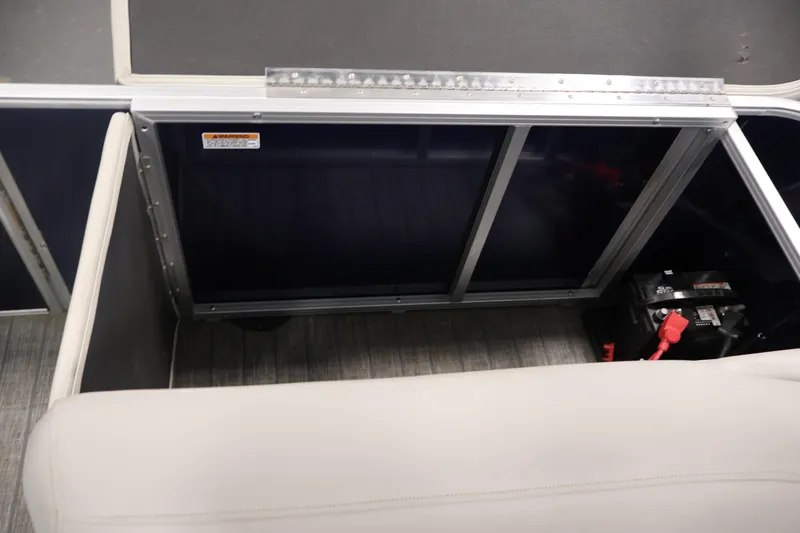Slide: The Image of Storage compartment of 2022 Sylvan 8520 Mirage pontoon boat with visible battery. - 32