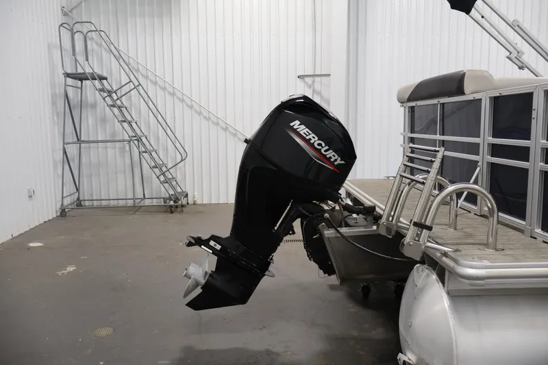 Slide: The Image of 2022 Sylvan 8520 Mirage pontoon boat with Mercury outboard motor in a storage facility. - 34