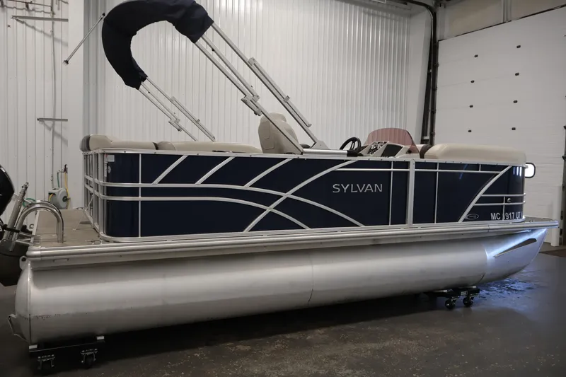 Slide: The Image of 2022 Sylvan 8520 Mirage pontoon boat in a garage setting. - 4