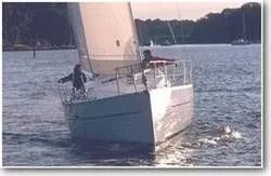 Slide: The Image of 2004 Beneteau 323 sailboat on calm water. - 2