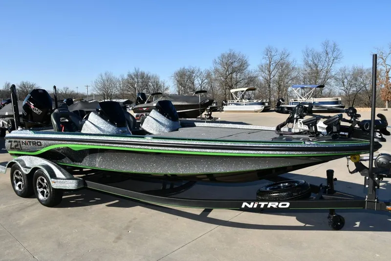 The Image of 2020 Nitro Z21 Pro bass boat with dual consoles and trailer in a parking lot. - 1