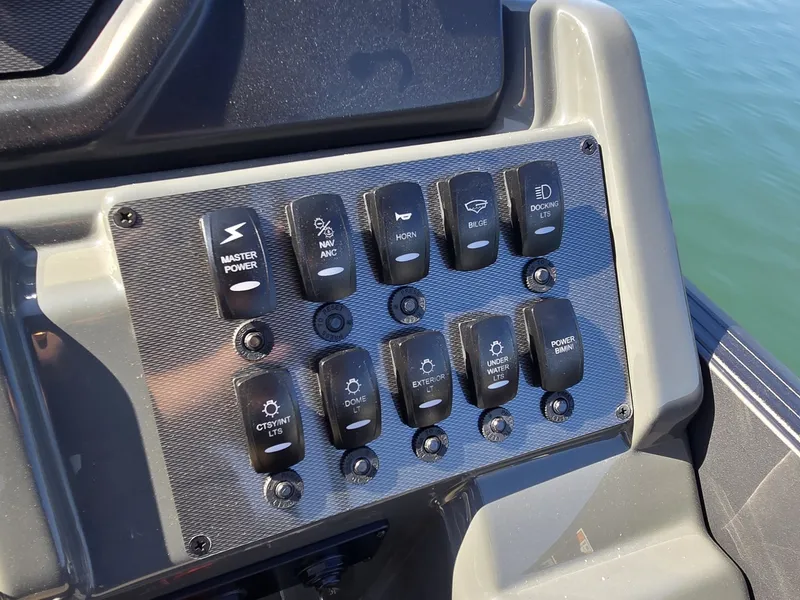Slide: The Image of The image shows a control panel with various switches on a Sylvan MIRAGE X3 ULZ boat. - 18