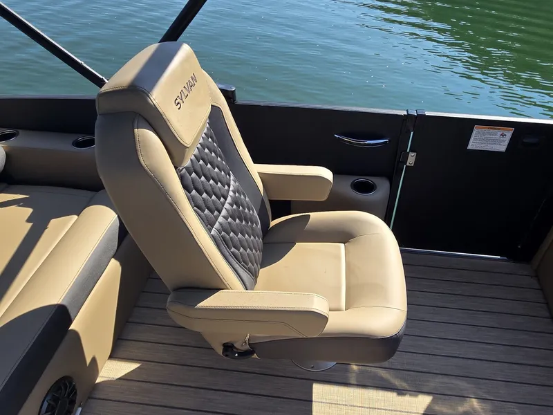 Slide: The Image of A luxurious, padded captain's chair on a boat, overlooking calm water. - 13