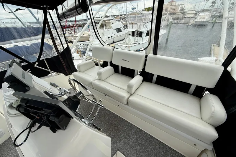 Slide: The Image of Interior of a 2000 Silverton 351 Sedan yacht with white seating and helm controls. - 15