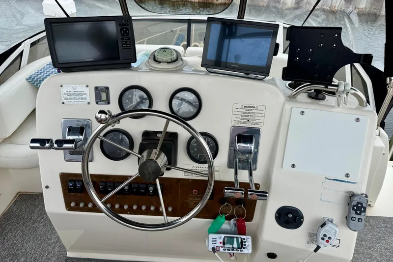 Slide: The Image of Cockpit of a 2000 Silverton 351 Sedan with steering wheel and navigation instruments. - 17