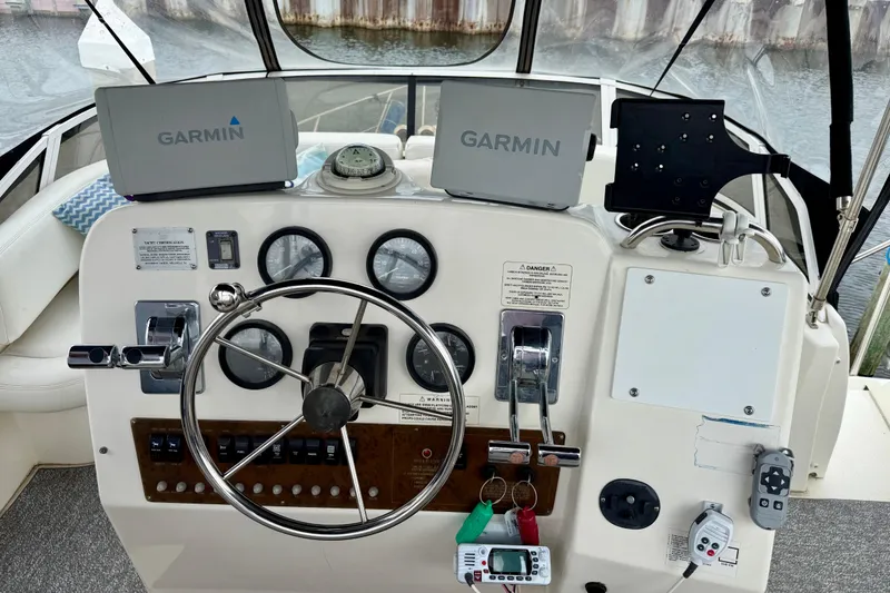 Slide: The Image of 2000 Silverton 351 Sedan helm with Garmin navigation displays and steering wheel. - 18