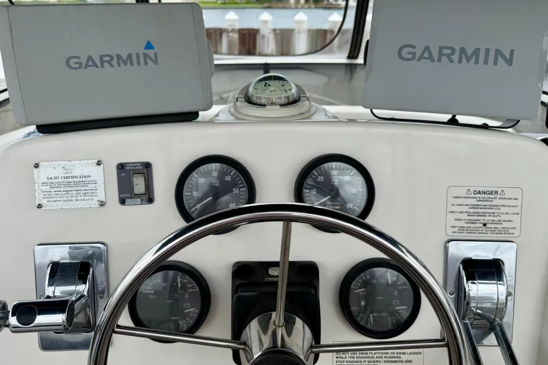 Slide: The Image of Helm of 2000 Silverton 351 Sedan with Garmin navigation displays and gauges. - 19