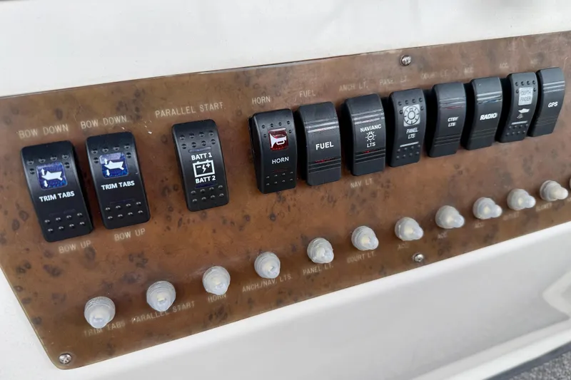 Slide: The Image of Control panel of a 2000 Silverton 351 Sedan boat with various switches and indicators. - 20