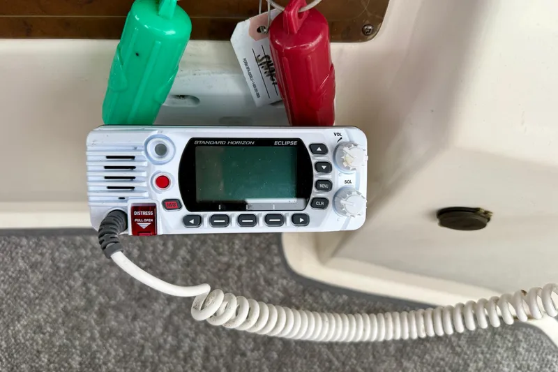 Slide: The Image of Marine radio on 2000 Silverton 351 Sedan boat, featuring distress button and coiled cord. - 23