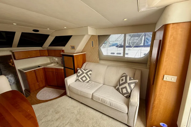 Slide: The Image of Interior of a 2000 Silverton 351 Sedan yacht with cozy seating and kitchenette. - 33