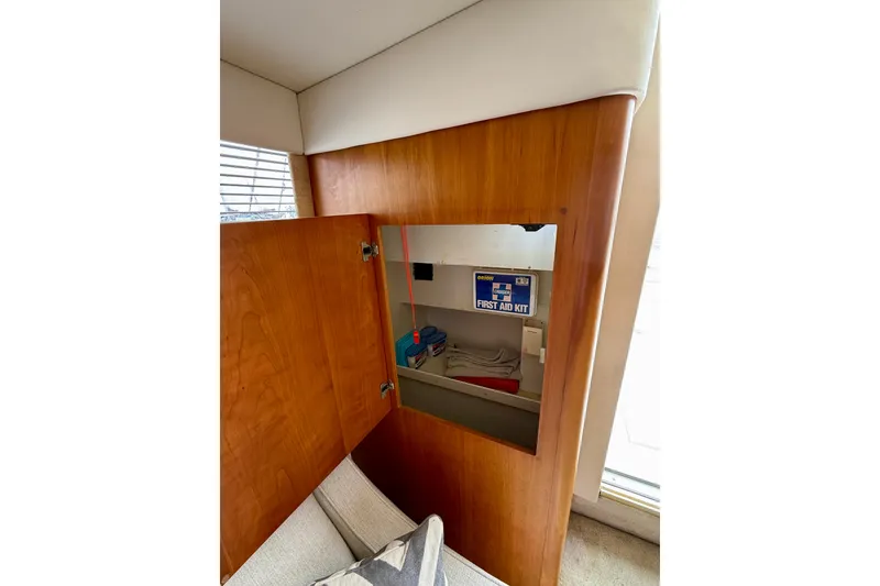 Slide: The Image of Interior of 2000 Silverton 351 Sedan showing wooden cabinet with first aid kit. - 37
