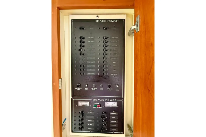 Slide: The Image of Electrical panel on a 2000 Silverton 351 Sedan boat, featuring 12V and 120V power controls. - 40
