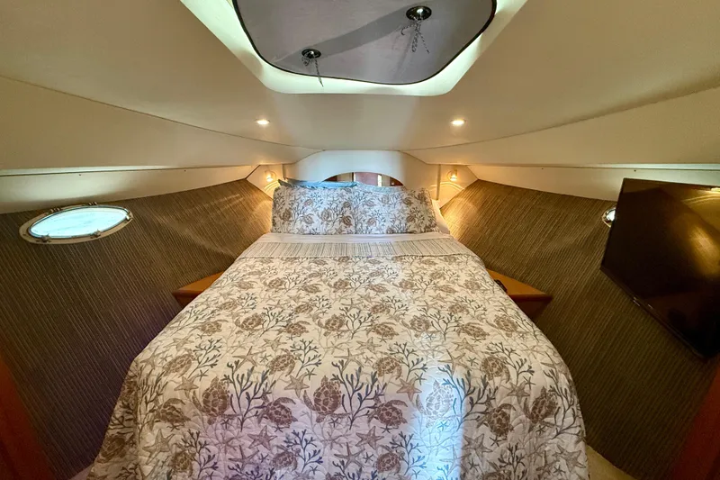 Slide: The Image of Luxurious bedroom interior of 2000 Silverton 351 Sedan yacht with elegant bedding and ambient lighting. - 42