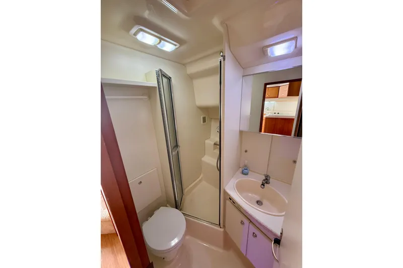 Slide: The Image of Bathroom interior of 2000 Silverton 351 Sedan yacht with shower, sink, and toilet. - 47