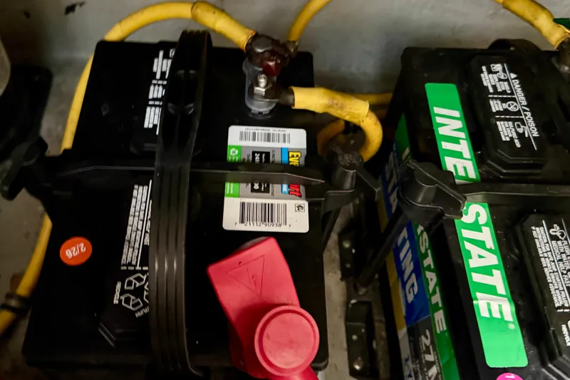 Slide: The Image of Batteries in a 2000 Silverton 351 Sedan with yellow cables and Interstate branding. - 51
