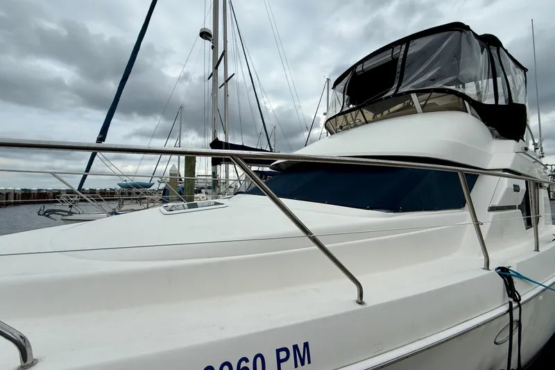 Slide: The Image of 2000 Silverton 351 Sedan yacht docked under cloudy skies. - 6