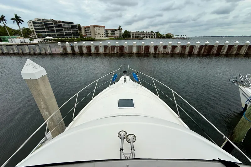 Slide: The Image of 2000 Silverton 351 Sedan yacht docked at marina with waterfront view. - 9