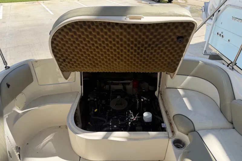 Slide: The Image of Open engine compartment of 2006 Sea Ray 240 Sundeck boat, showing interior details. - 34