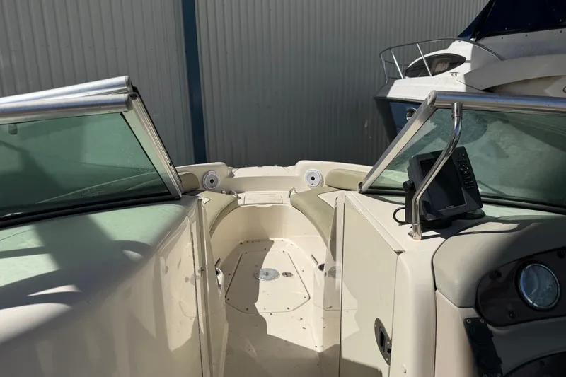 Slide: The Image of 2006 Sea Ray 240 Sundeck boat interior with windshield and seating area. - 42