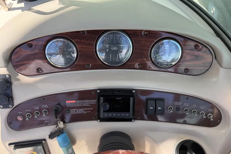 Slide: The Image of Dashboard of a 2006 Sea Ray 240 Sundeck boat with gauges and controls. - 23