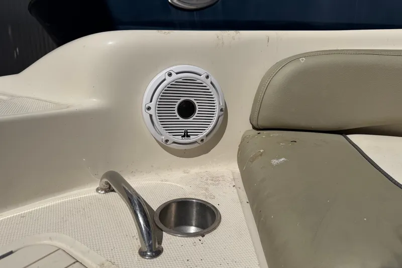 Slide: The Image of Boat interior of 2006 Sea Ray 240 Sundeck with speaker and cup holder. - 55