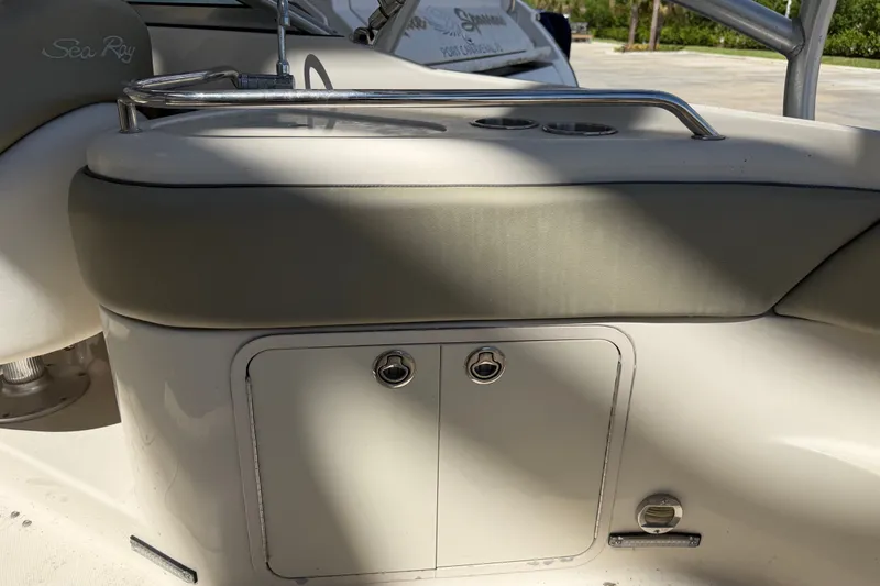 Slide: The Image of 2006 Sea Ray 240 Sundeck boat interior with storage compartment and cushioned seating. - 30