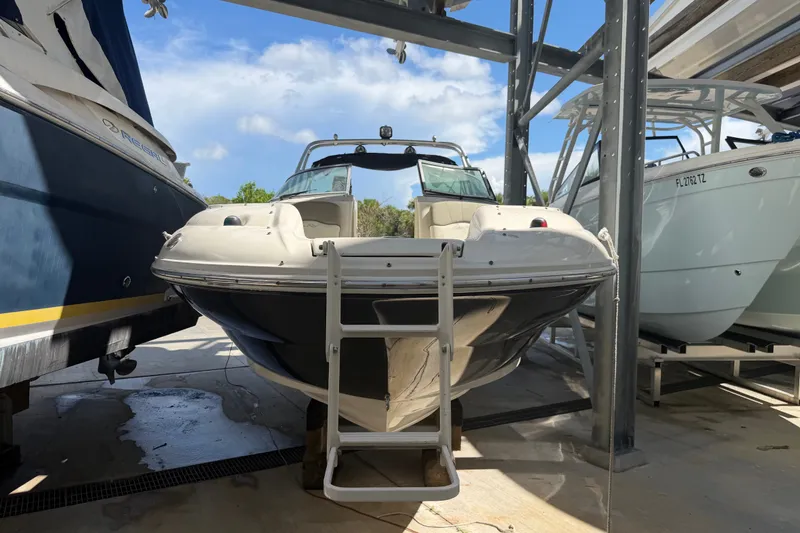 Slide: The Image of 2006 Sea Ray 240 Sundeck boat on dry dock with ladder access. - 2