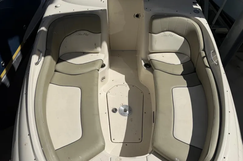 Slide: The Image of 2006 Sea Ray 240 Sundeck boat interior with beige seating and storage compartment. - 11