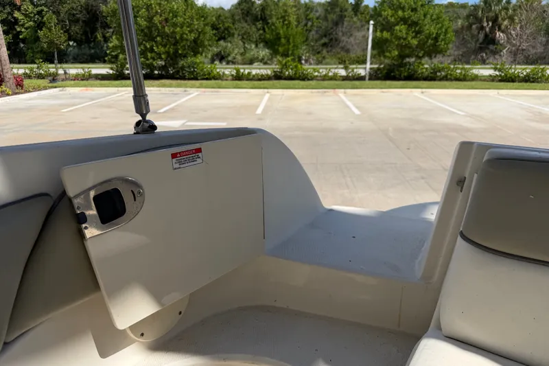 Slide: The Image of Interior view of a 2006 Sea Ray 240 Sundeck boat, showing seating and storage compartment. - 32