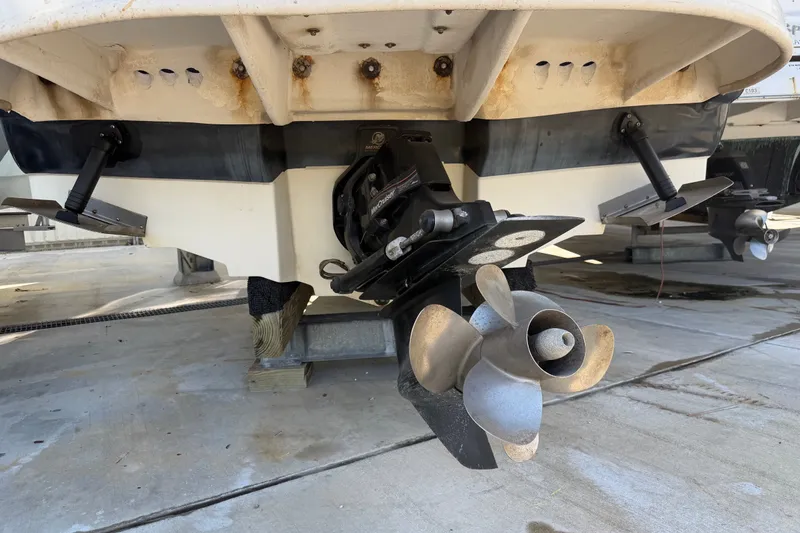 Slide: The Image of Rear view of a 2006 Sea Ray 240 Sundeck boat showing the propeller and stern drive. - 7