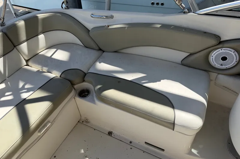 Slide: The Image of 2006 Sea Ray 240 Sundeck interior with cushioned seating and built-in speaker. - 35