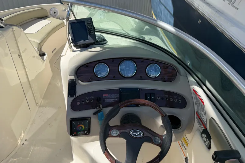 Slide: The Image of 2006 Sea Ray 240 Sundeck dashboard with steering wheel and instrument panel. - 21
