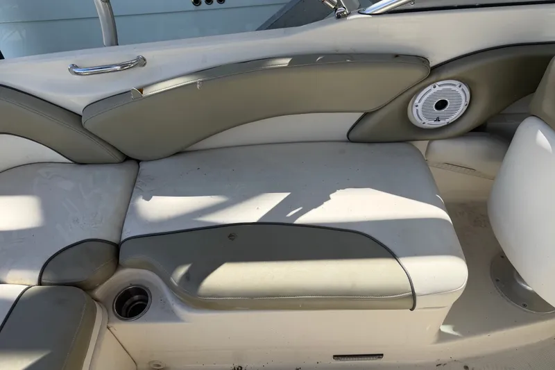 Slide: The Image of 2006 Sea Ray 240 Sundeck interior seating with cup holder and speaker. - 38