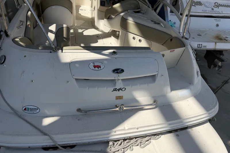 Slide: The Image of 2006 Sea Ray 240 Sundeck boat interior with seating and storage compartments. - 40