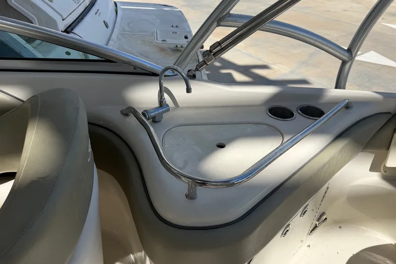 Slide: The Image of 2006 Sea Ray 240 Sundeck boat interior with sink and cup holders. - 28